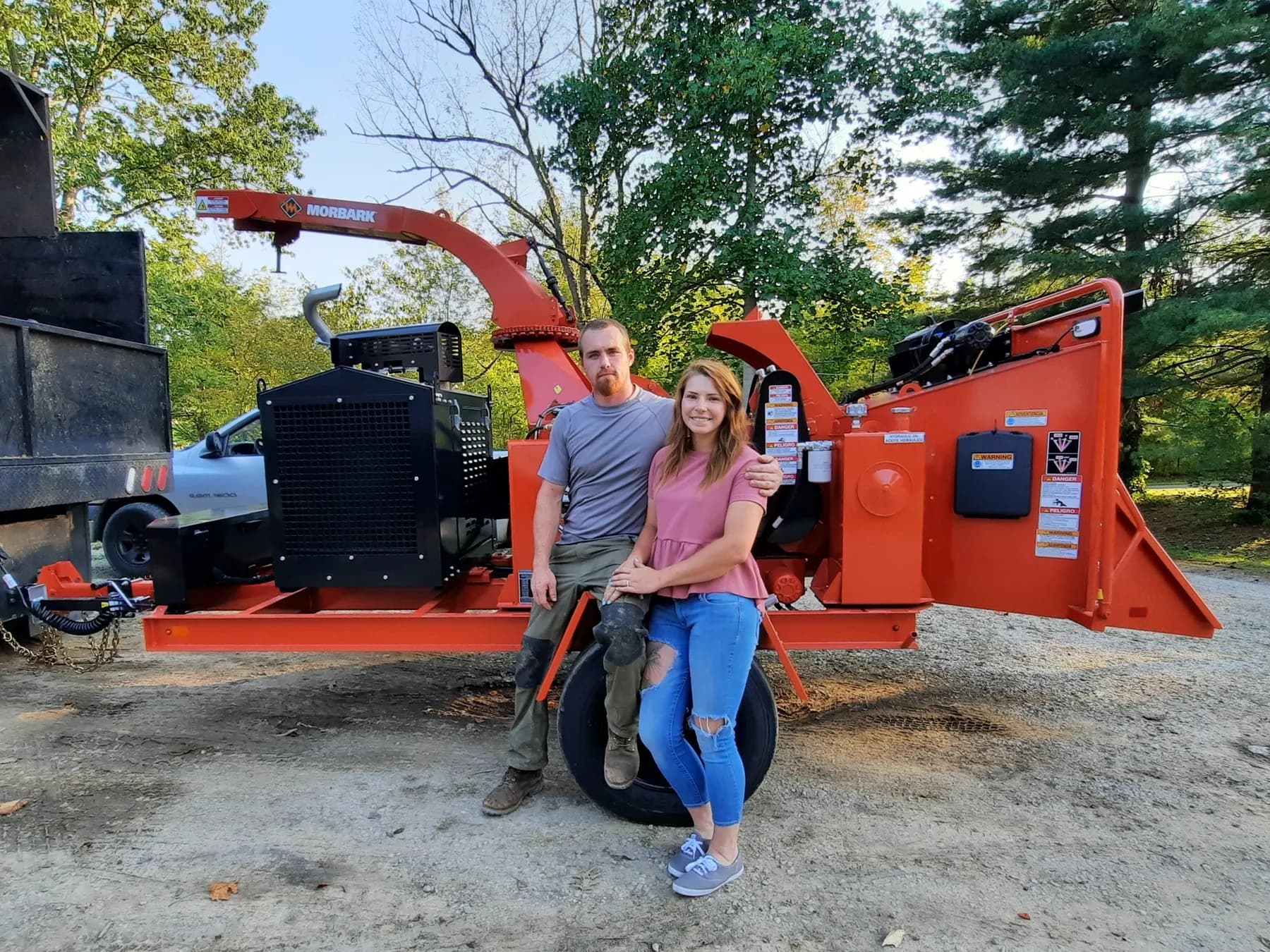 Logan and his wife, owners of Ghost Tree Service, with their Morbark wood chipper in Medina County, Ohio